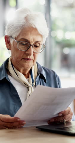 Documents, confused and old woman in home, finance planning or frustrated with taxes. Savings, loan rejection or senior person in lounge, pc or paperwork for budget review, mortgage invoice or stress