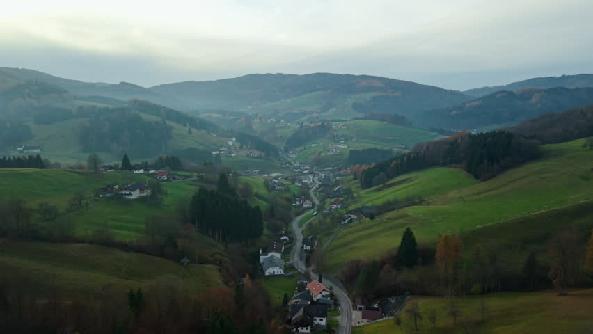 Aerial flyover of misty alpine valley in Altmunster, Austria, in autumn