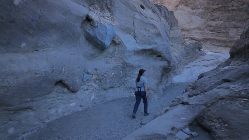 Gimbal wide shot following hikers through scenic Mosaic Canyon in Death Valley National Park, California. 4K