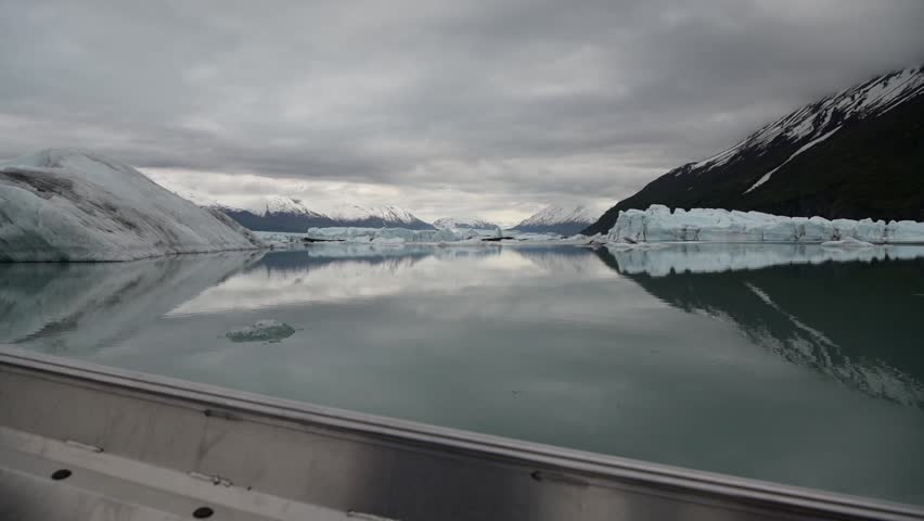 Cinematic handheld POV footage of a small boat navigating through ice chunks and icebergs on Matanuska Glacier in Alaska.  Ideal for dramatic, adventure, relaxing, travel, outdoor, and glacier-themed projects. 