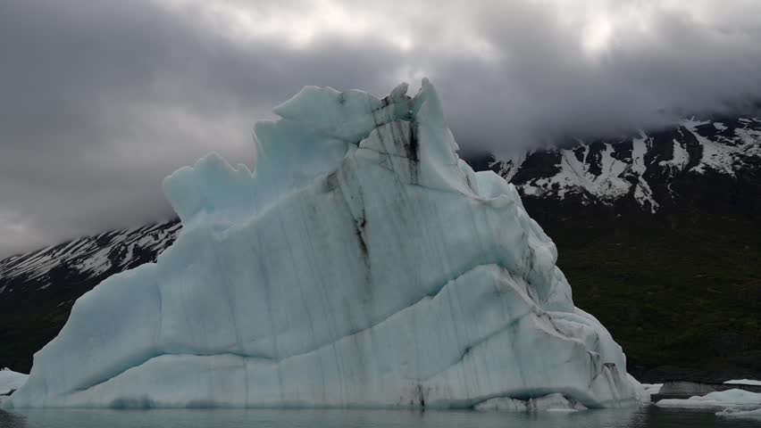 Cinematic handheld POV footage of a small boat navigating through ice chunks and icebergs on Matanuska Glacier in Alaska.  Ideal for dramatic, adventure, relaxing, travel, outdoor, and glacier-themed projects. 