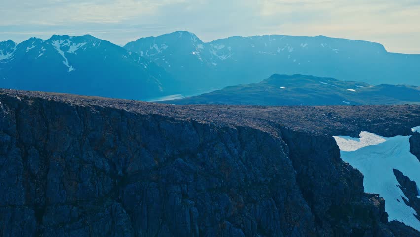 A Vast Rocky Plateau Overlooks Distant Mountain Ranges Near Middagsfjellet in Sandland, Loppa Kommune, Finnmark, Norway - Drone Flying Forward