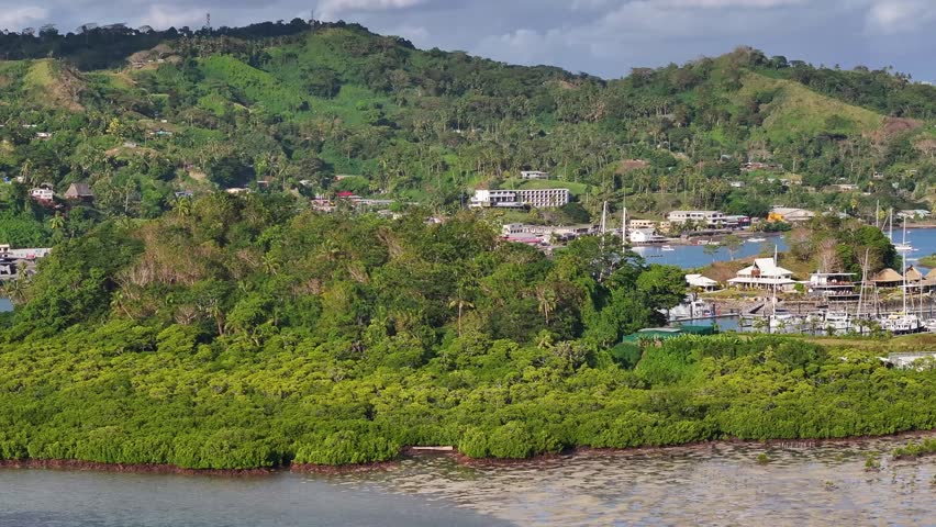 Marina with boats aerial reveal of coastal town of Savusavu in Fiji. Travel destination, Pacific Ocean