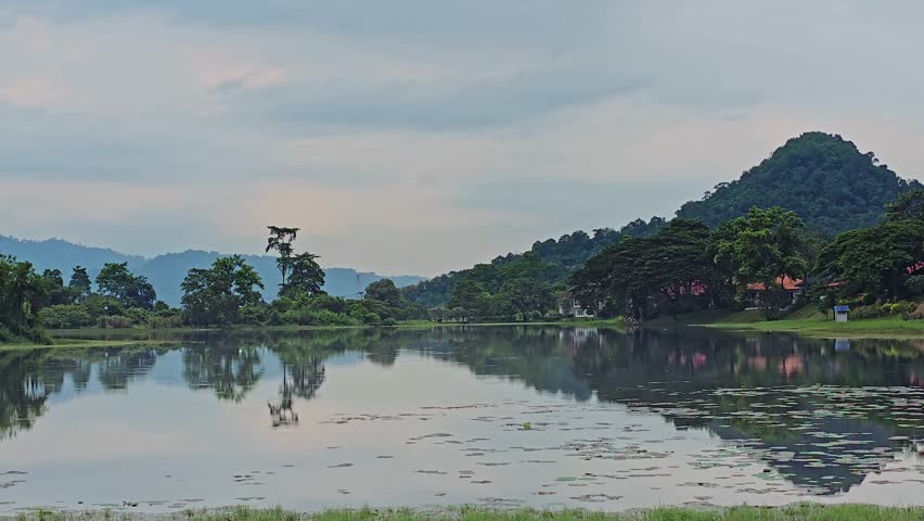 Large Pond Overlooking Scenic Landscape in Nakhon Nayok Thailand on a Calm Day