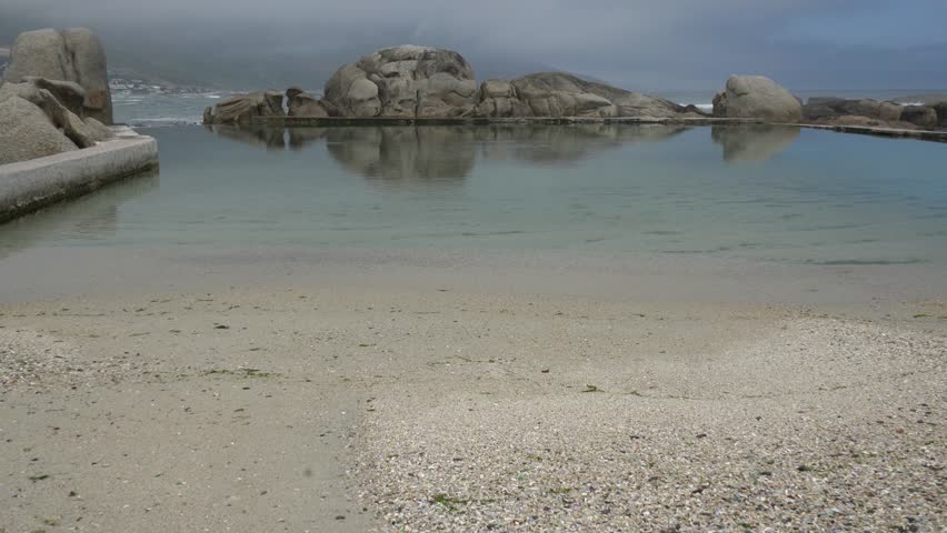 Beach tidal pool along a rocky shoreline