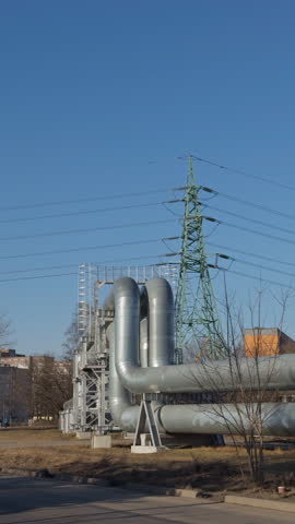 City power infrastructure. Urban electrical and heating systems. Metropolitan power station featuring transformers and highvoltage lines