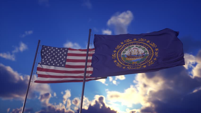 United States and New Hampshire State Flags Waving Against Dramatic Sky