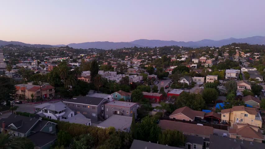 Aerial view of Downtown Los Angeles skyline at sunset with city streets and urban landscape