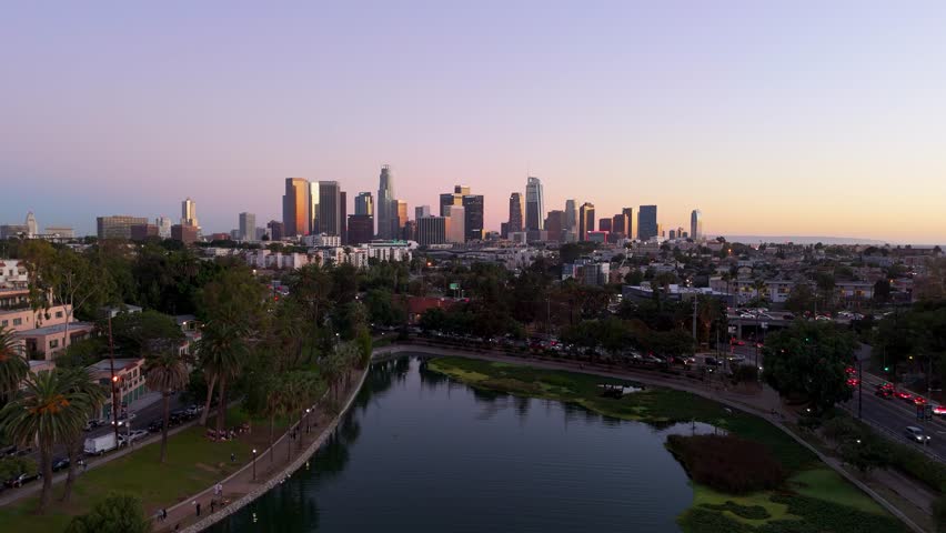 Aerial panoramic view of Downtown Los Angeles skyline with Echo Park Lake at sunset, November 25 2025