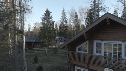 Drone Ascending above Forest Cottages