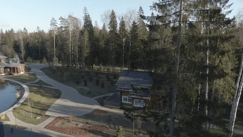 Drone Flying Backward above Forest Resort