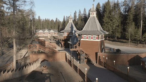 Drone Ascending Forward over Wooden Towers
