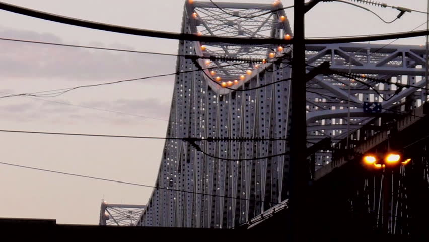 New Orleans, Louisiana -  June, 2011 - Close up of buses passing in front of Crescent City Connection.