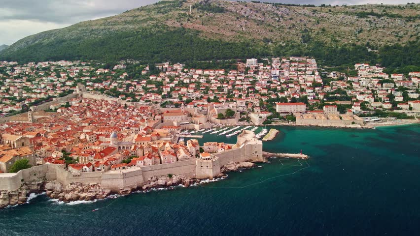 Coastal Historic Panorama. Ancient Cityscape Along Coastline. Old Dubrovnik Towers Over Azure Sea