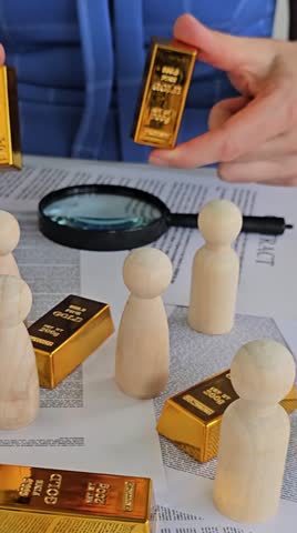 People examining gold bars with a magnifying glass on a table with wooden figures in a detailed setting