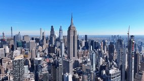 Panoramic aerial view of New York City's iconic Midtown Manhattan skyline on a clear day, featuring the Empire State Building at center, surrounded by modern skyscrapers like 432 Park Avenue. - Powered by Shutterstock - Get 15% off with code: PIKWIZARD15