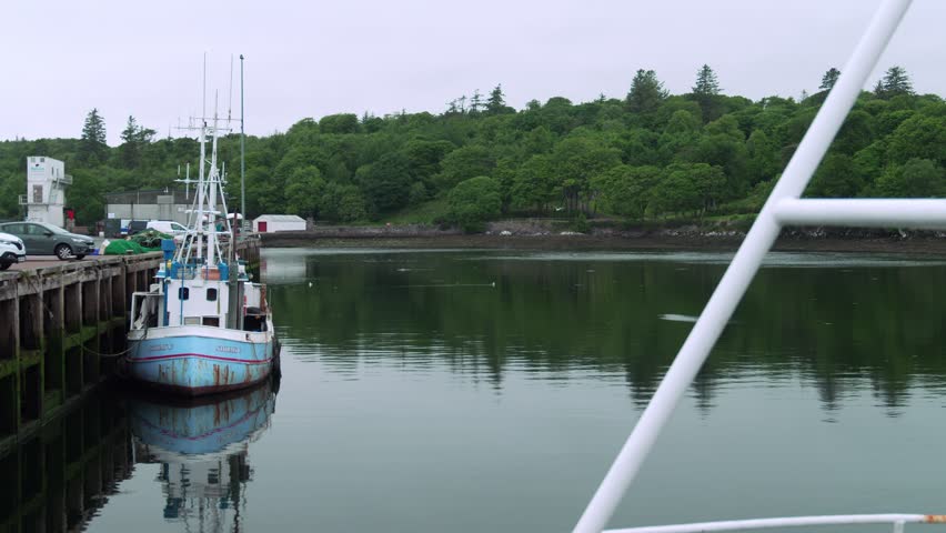 Static shot of a fishing boat docked at Stornoway harbour on the Isle of Lewis.