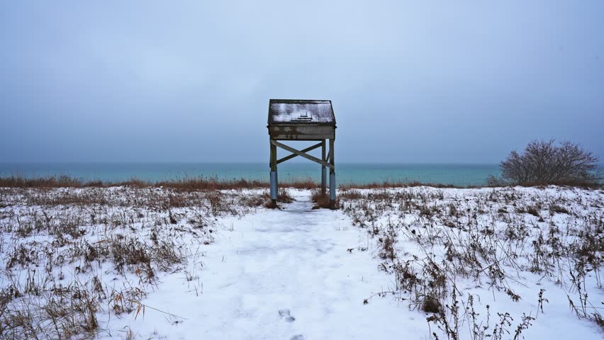 Wooden Shelter on the Footpath Coastline During Winter Snow at Dawson’s Point near Darlington in Courtice Ontario Canada. Dolly Shot.