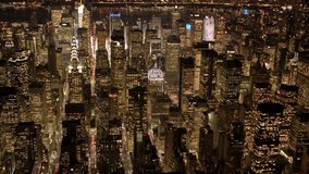 Captivating aerial view of Midtown Manhattan at night, showcasing illuminated skyscrapers lining a bustling avenue with streams of traffic lights below. - Powered by Shutterstock - Get 15% off with code: PIKWIZARD15
