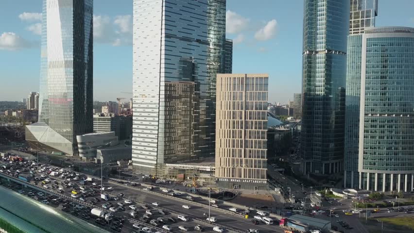 Corporate business tower skyline with modern skyscrapers and tall office buildings beside the busy road a blue sky