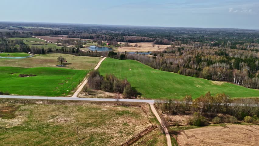 Aerial view over a rural area with meadows and forests.