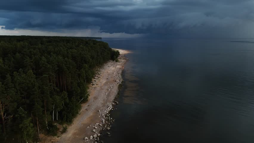 Cinematic View of Stormy Sky Over Beach, Forest, and Sea