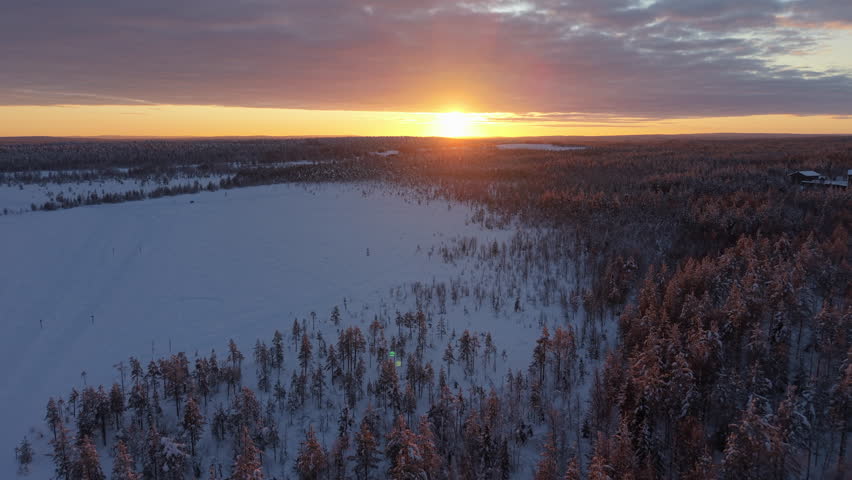 Snow-Covered Lapland Winter Landscape - Aerial Dolly In at Sunset