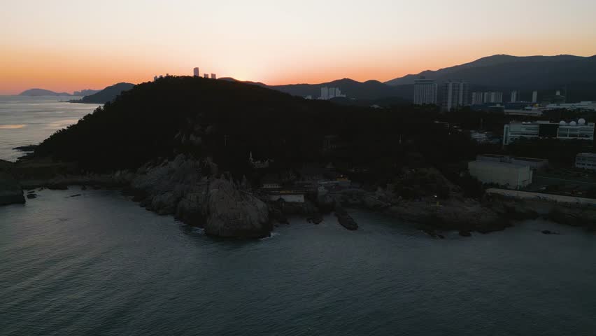 Aerial view approaching the Haedong Yonggungsa Temple, dusk in Busan, South Korea