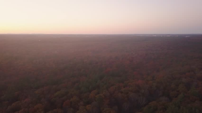 Beautiful forest during autumn at sunset. Malden, USA. Aerial, tilt down