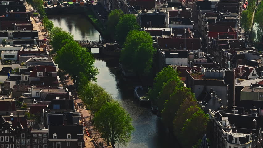 Aerial view of Amsterdam city, Netherlands. Aerial view of canals with boats in the center city. Cityscape narrow old houses, canals, old centre 
