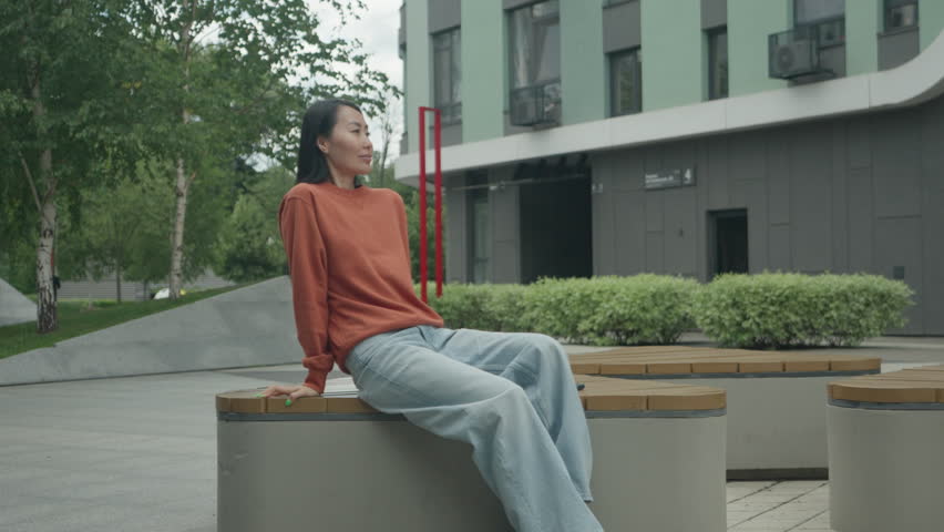 Tired Woman Relaxing And Taking Deep Breath While Sitting Outdoors In City