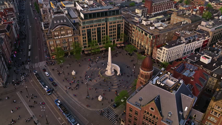 Aerial view of Amsterdam city at sunset, Netherlands. Amsterdam Central Station. Canals with boats in the center city, old centre 