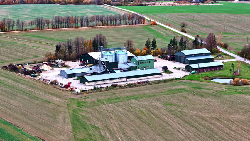 Aerial view of an agricultural farm with storage and silos amidst the fields.