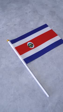 Flag of Costa Rica country on grey background. Vertical shot.