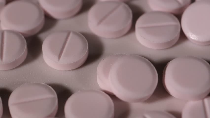 Pink pills. Medical tablets. Slow motion video. High quality 4k footage