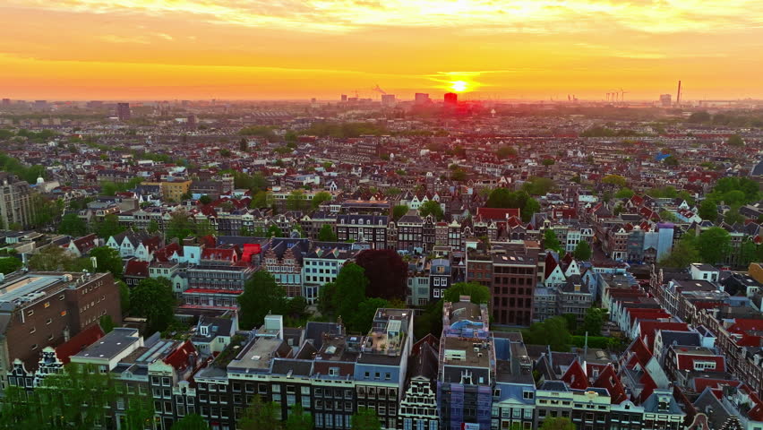 Aerial view of Amsterdamat at sunset with canals, boats. Historic Dutch city of Amsterdam, capital of the Netherlands