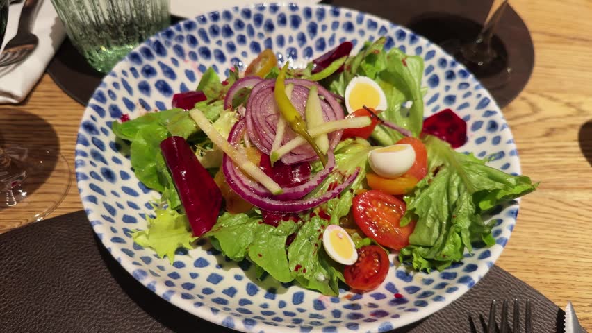 Salad with lettuce, beetroot, tomato, eggs and a pickle vinaigrette. High quality 4k footage