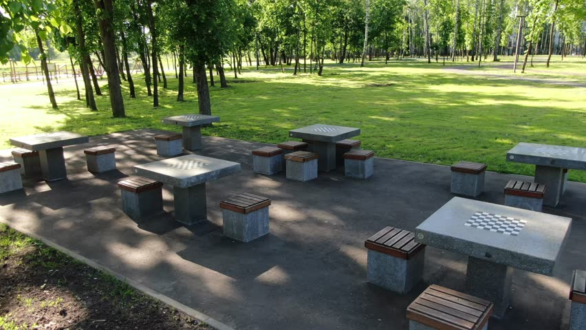 Drone lifting above chess tables in park