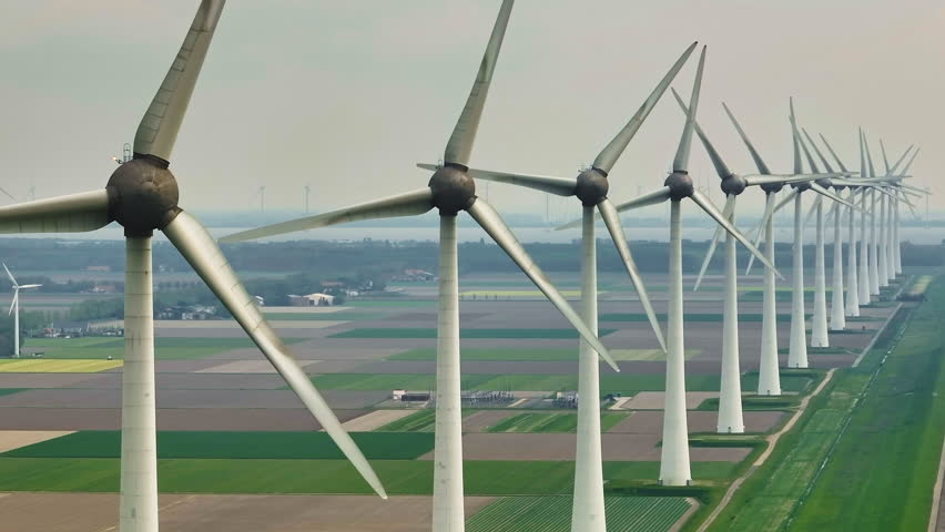 Aerial view of offshore windmill park with blue sky, windmill park in the sea, aerial view of wind turbine, Netherlands