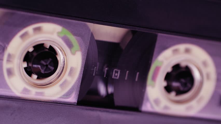 Retro radio tape recorder, audio cassette close-up. Listening to music, old radio boom box player, macro of vintage music listening. 