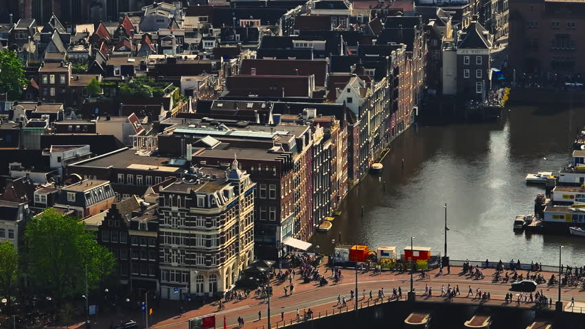 Aerial view of Amsterdam city, Netherlands. Aerial view of canals with boats in the center city. Cityscape narrow old houses, canals, old centre 