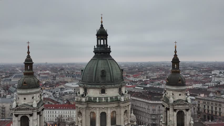 Aerial descending over the grand central dome and twin bell towers of St. Stephen