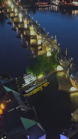  Aerial view of Prague at night. The most beautiful view of the Charles Bridge at night and beautifully illuminated by lights. Czech Republic