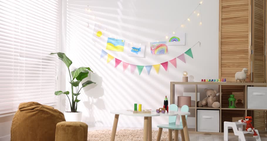 Stylish child's room with furniture, toys, beautiful drawings and bright flags, camera moving in. Interior design