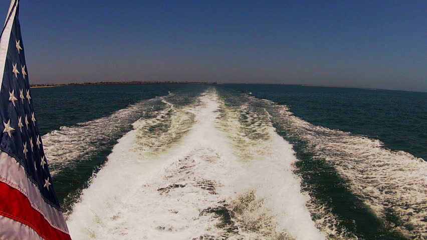 The wake of a large fast boat (the Aqualink II) or yacht heading away from shore
