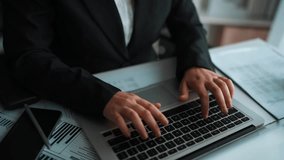Business professional working with digital AI technology on laptop, surrounded by data visualizations and analytics in a modern office setting Sigmoid - Powered by Shutterstock - Get 15% off with code: PIKWIZARD15