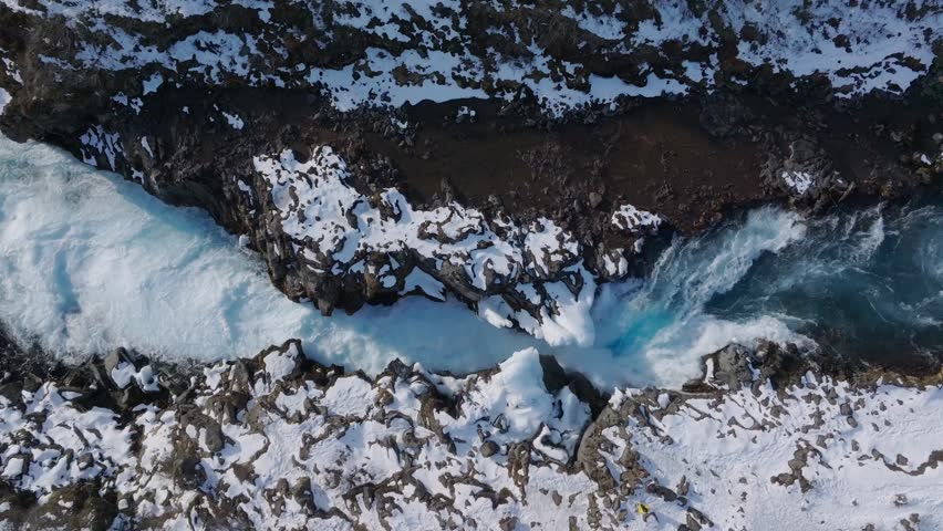 Cinematic drone descending over Bruarfoss where Bruara river cuts Iceland canyon
