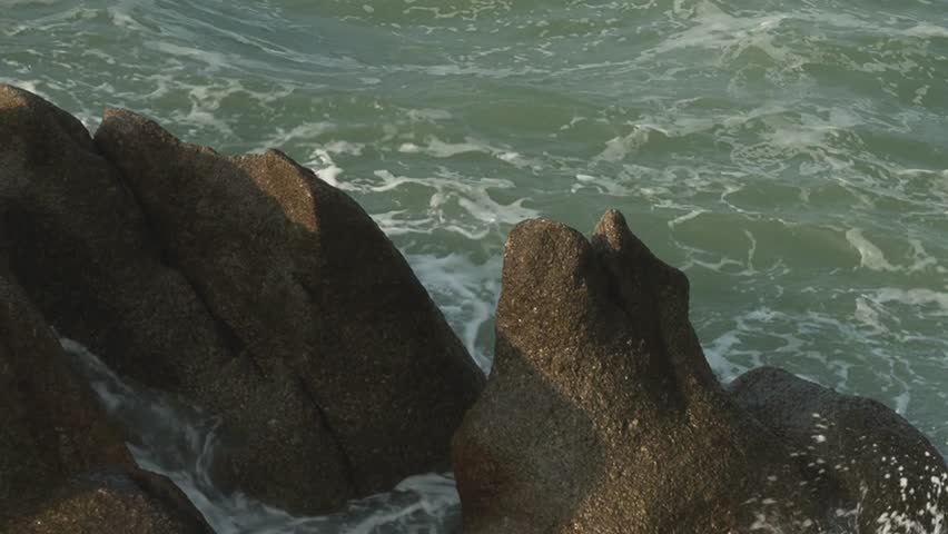 Ocean waves over big rocks
