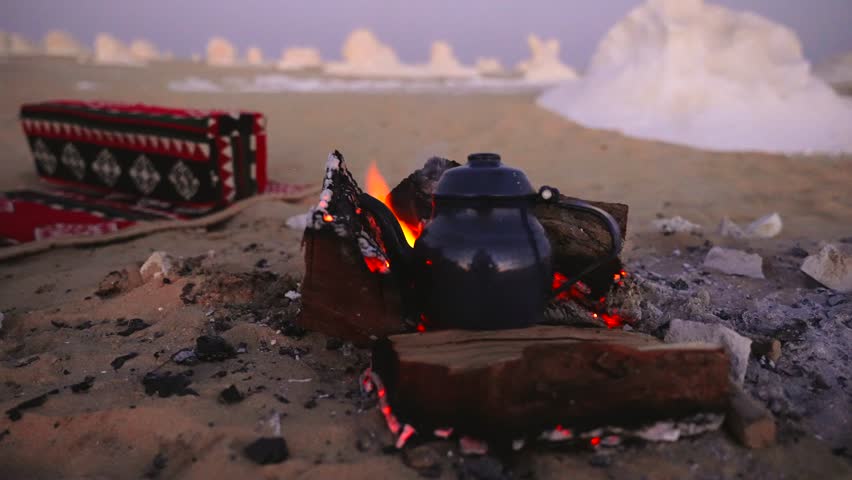 Bedouin Camp Campfire with Traditional Rugs and Tea Kettle in White Desert Egypt