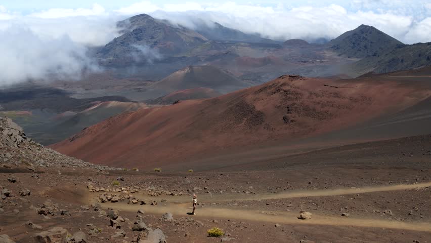 Beautiful girl walking on the surface inside Haleakala volcano and craters, Maui Hawaii. High quality 4k footage